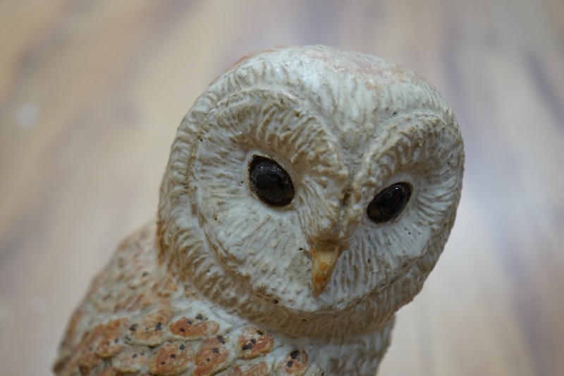 Audrey Carter, three studio pottery animal models, an owl, otter and badger, 37cm. Condition - good